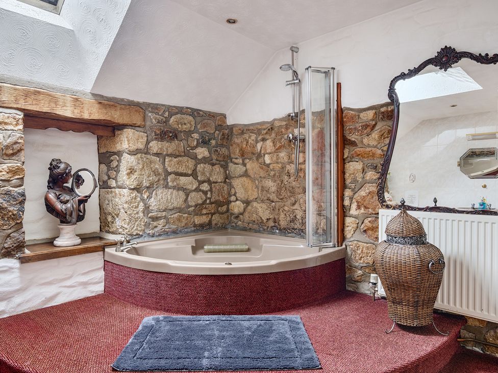 A bathroom with a bathtub and shower at Chapel Green in Polgooth