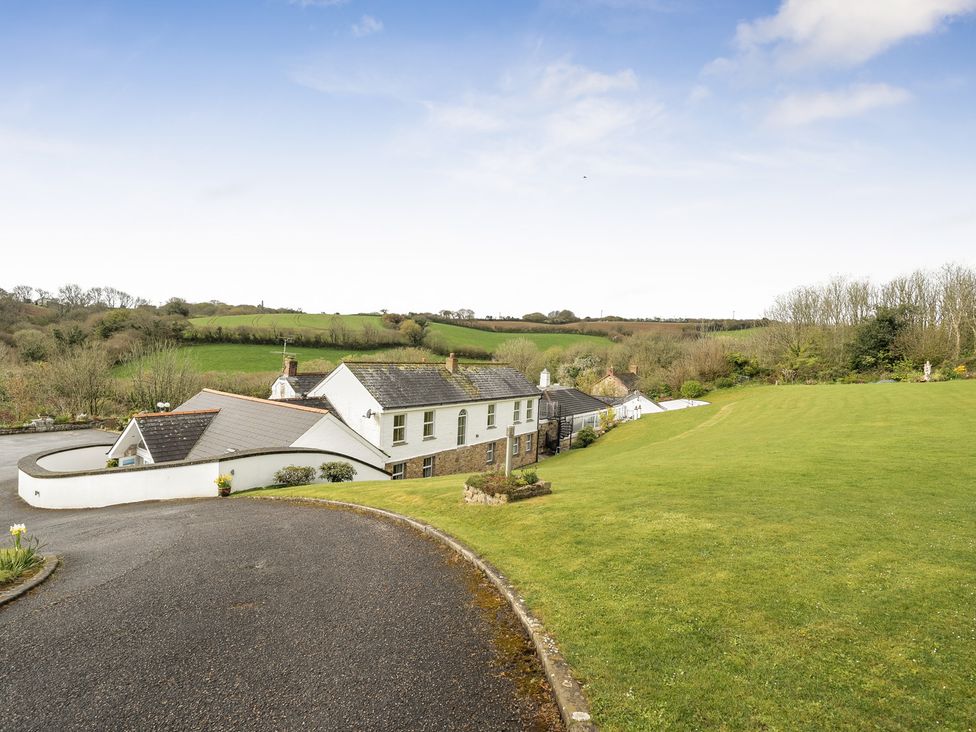 A house with surrounding land and trees at Chapel Green in Polgooth