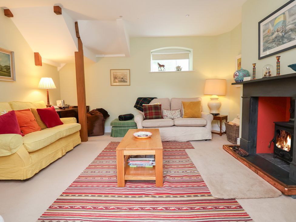 A living room with a sofa and coffee table at Bryn Howell Stables in Trevor near Llangollen