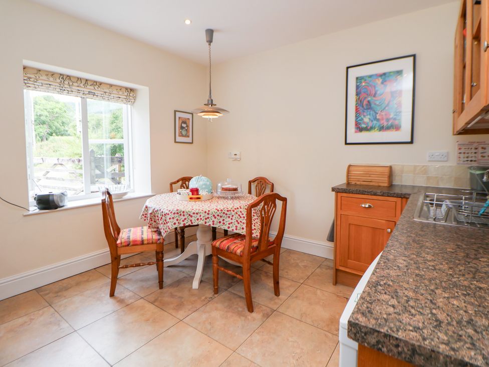 A kitchen with a table and chairs at Bryn Howell Stables Trevor near Llangollen
