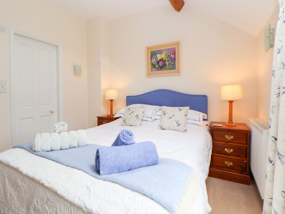A bedroom with a double bed and bedside table at Bryn Howell Stables Trevor near Llangollen