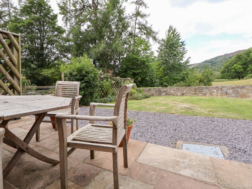 An outdoor dining area with a table and chairs at Bryn Howell Stables Trevor near Llangollen