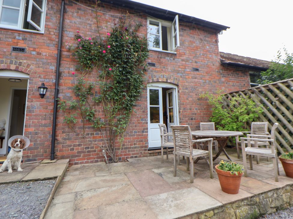 An outdoor patio with a table and chairs at Bryn Howell Stables Trevor near Llangollen