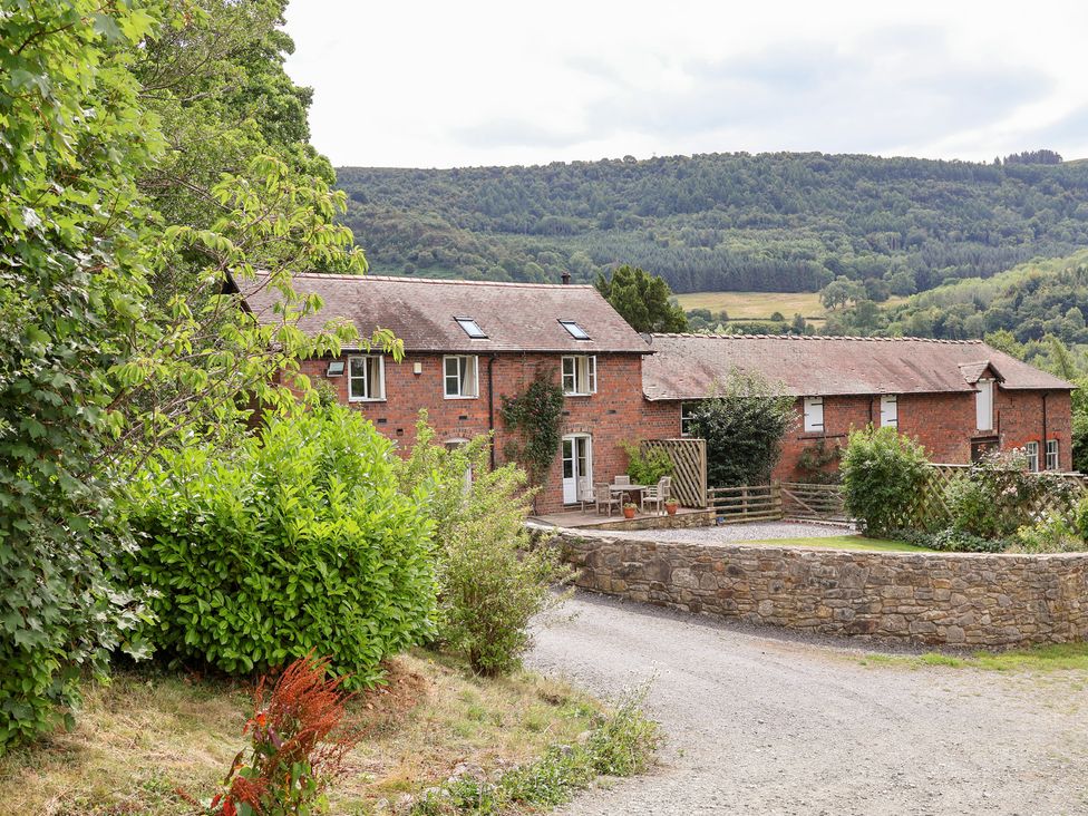 A building with garden and road near mountains at Bryn Howell Stables Trevor near Llangollen