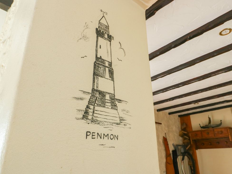 A wall with a drawing of a lighthouse labeled Penmon at Crow's Nest Cottage in Tynygongl near Benllech