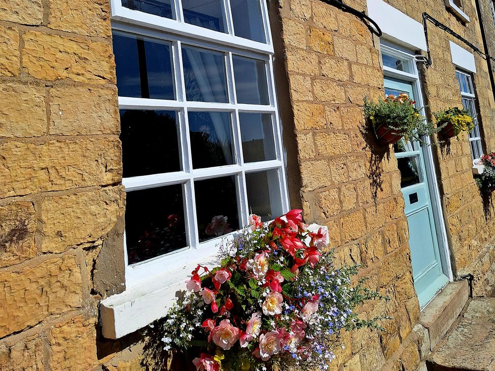 An exterior view of windows and a door with flower boxes at Boundcliffe Farm Allerston near Pickering