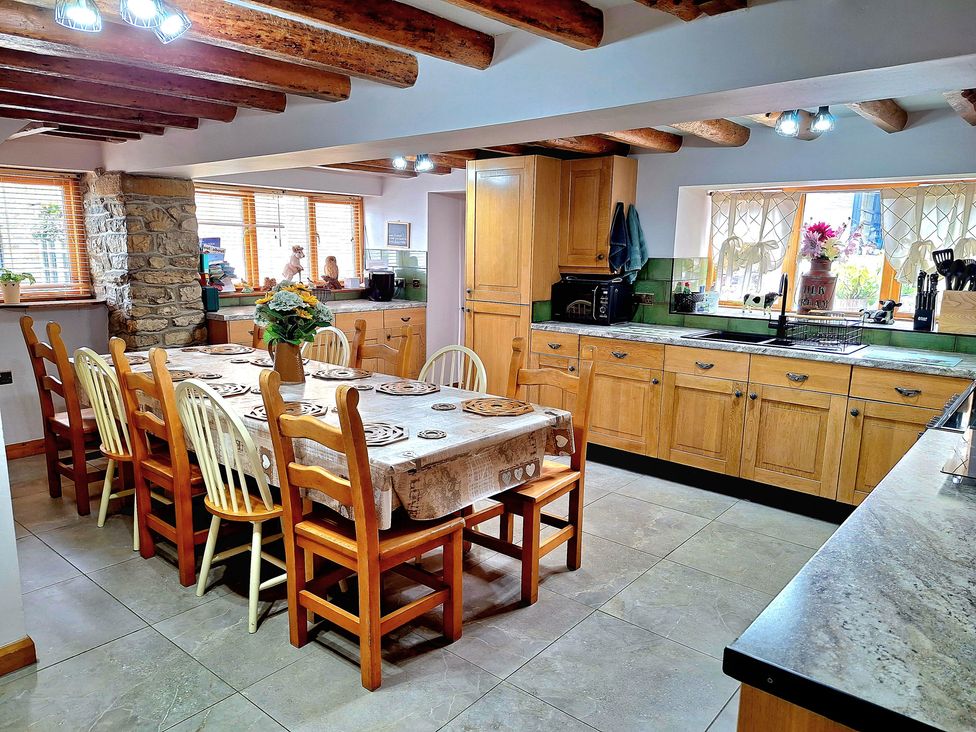 A kitchen with a dining table and chairs at Boundcliffe Farm in Allerston near Pickering