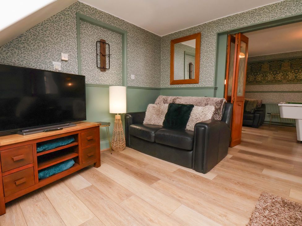 A living room with a sofa and television at Boundcliffe Farm in Allerston near Pickering
