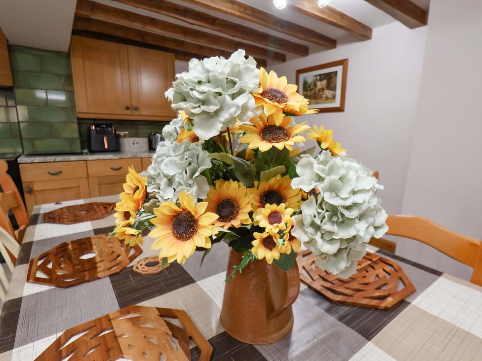 A kitchen with a table decorated with flowers at Boundcliffe Farm Allerston near Pickering