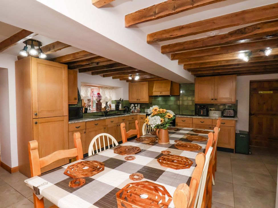 A kitchen with cabinets, table and appliances at Boundcliffe Farm in Allerston near Pickering