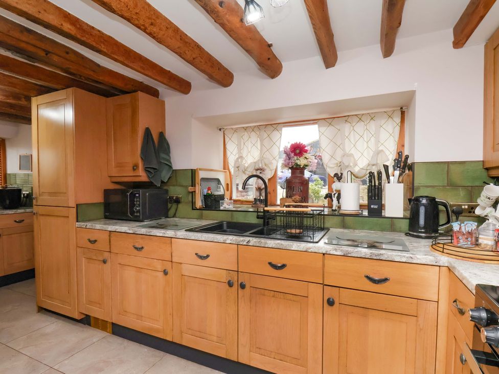A kitchen with wooden cabinets and appliances at Boundcliffe Farm in Allerston near Pickering