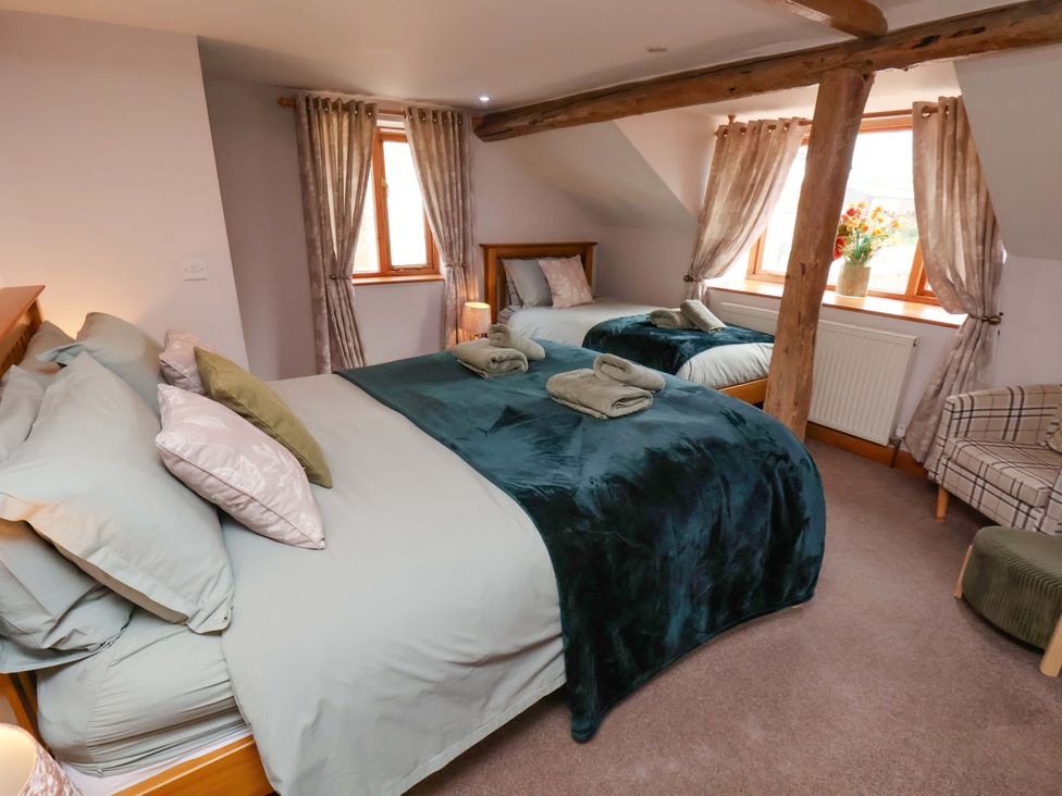 A bedroom with two beds and a window at Boundcliffe Farm Allerston near Pickering