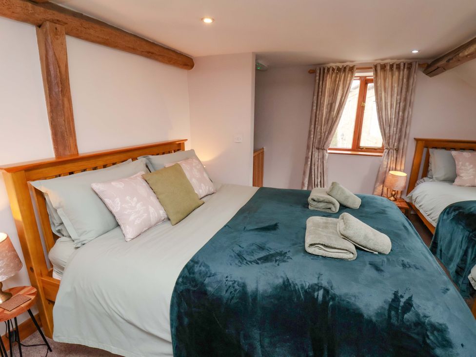 A bedroom with two beds and a window at Boundcliffe Farm in Allerston near Pickering