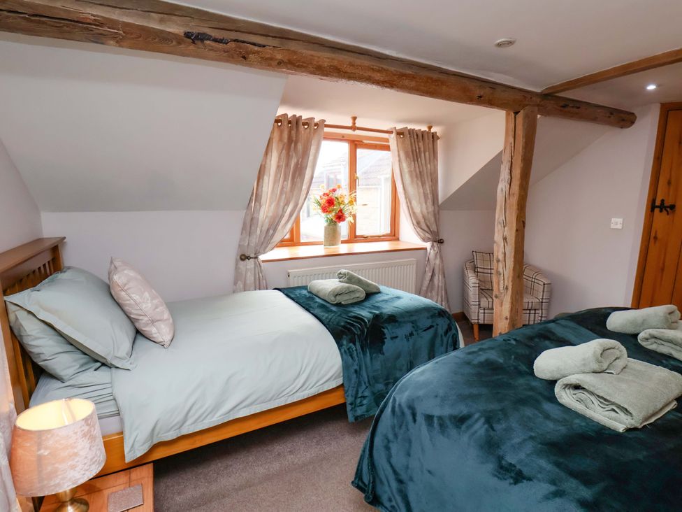 A bedroom with two beds and a window at Boundcliffe Farm in Allerston near Pickering
