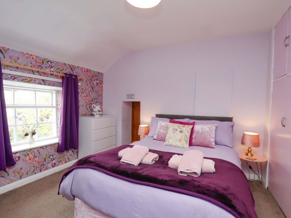 A bedroom with a bed and dresser at Boundcliffe Farm Allerston near Pickering