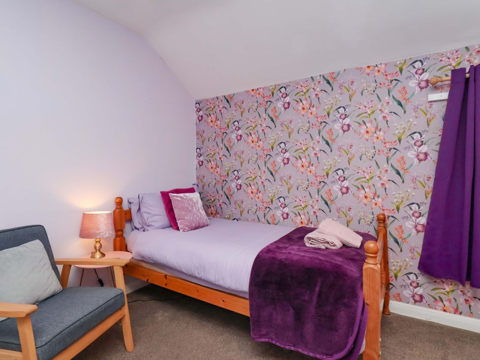 A bedroom with a single bed and a chair at Boundcliffe Farm in Allerston near Pickering