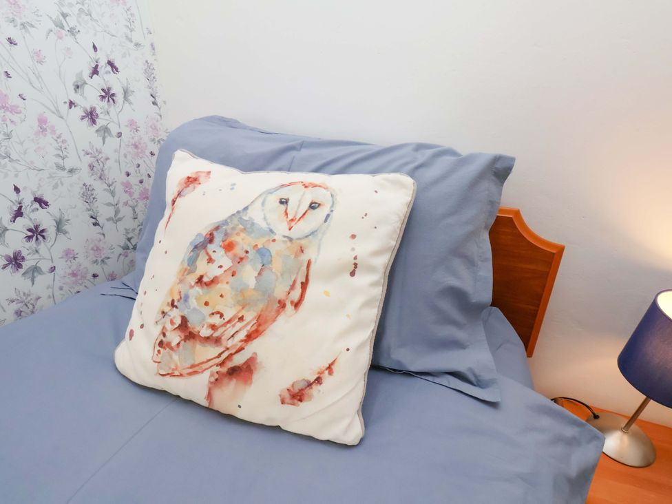 A pillow featuring an owl on a bed at Boundcliffe Farm in Allerston near Pickering