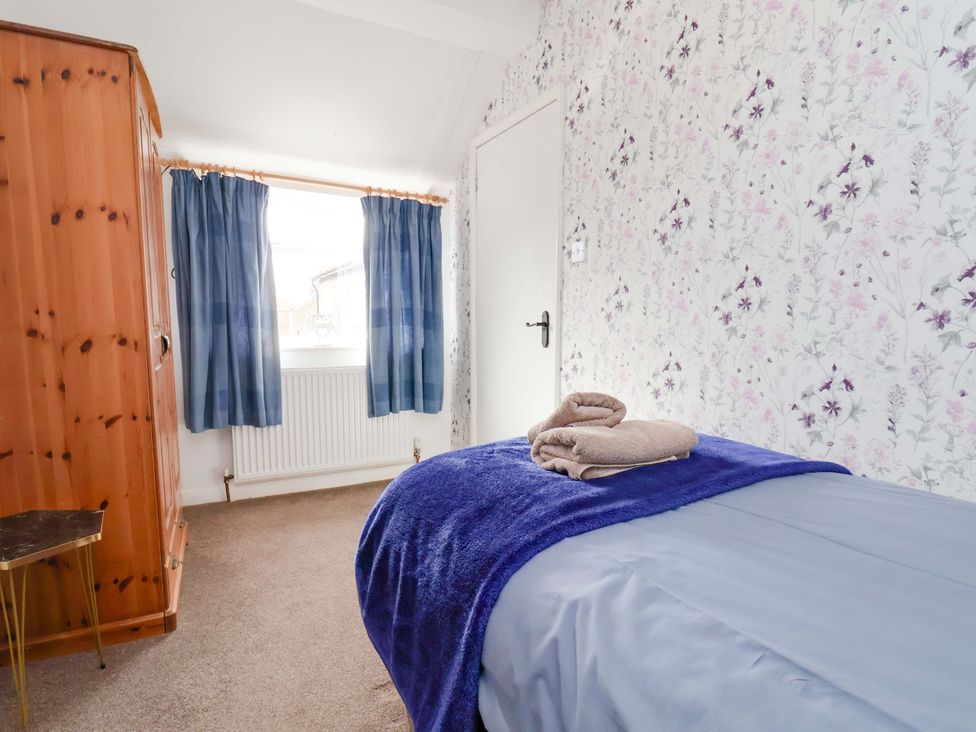 A bedroom with a bed and wardrobe at Boundcliffe Farm in Allerston near Pickering