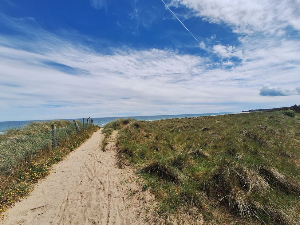 A sandy path leading to the ocean at 19 River Glen, Curracloe, County Wexford