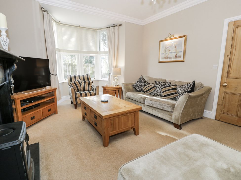 A living room with a television and coffee table at Tyddyn Goronwy in Talybont
