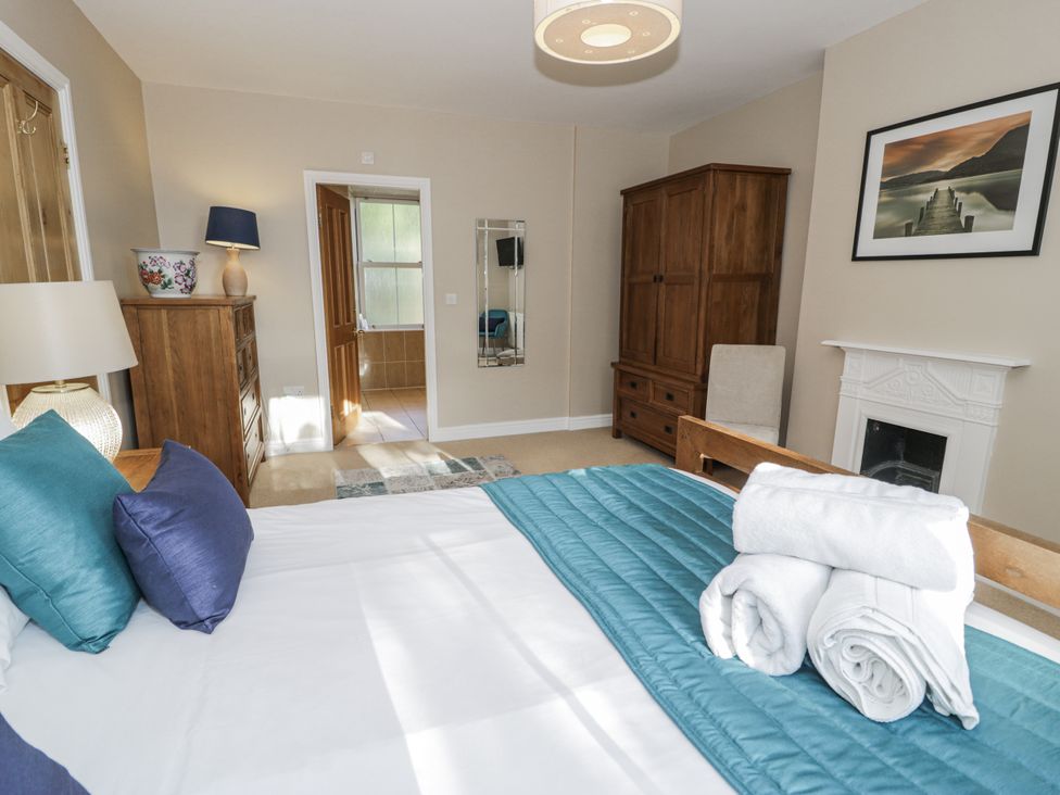 A bedroom with a bed and dresser at Tyddyn Goronwy in Talybont