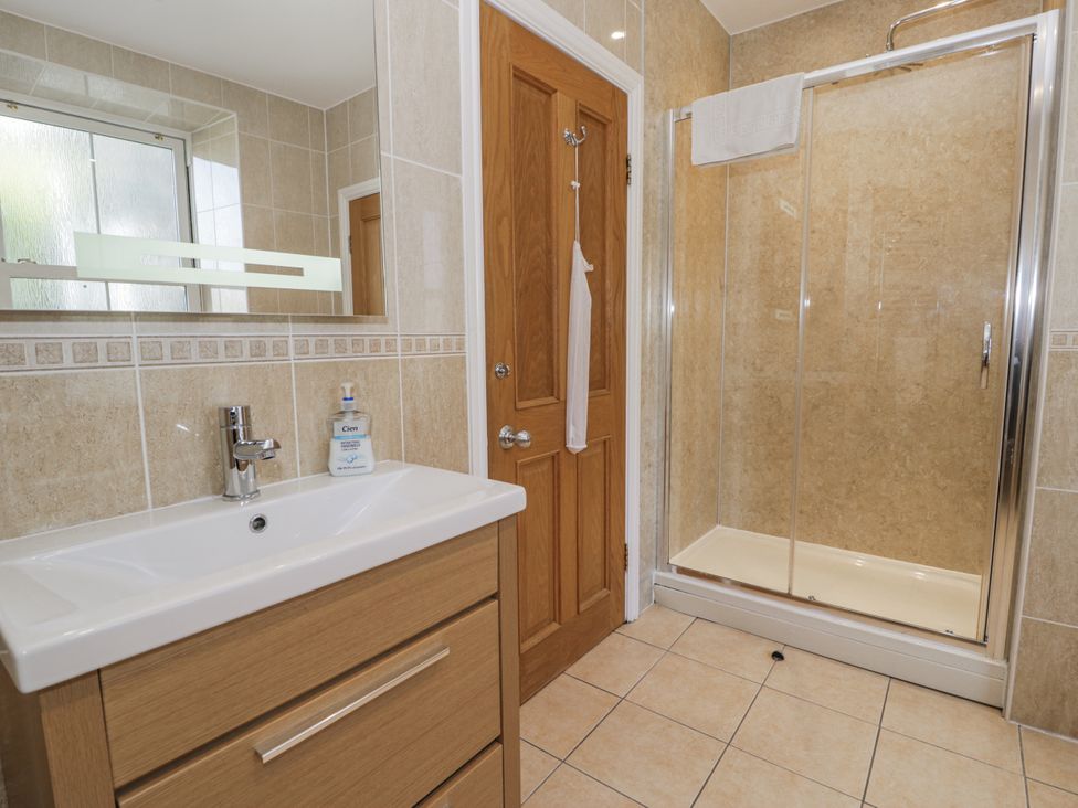 A bathroom with a sink and shower at Tyddyn Goronwy in Talybont