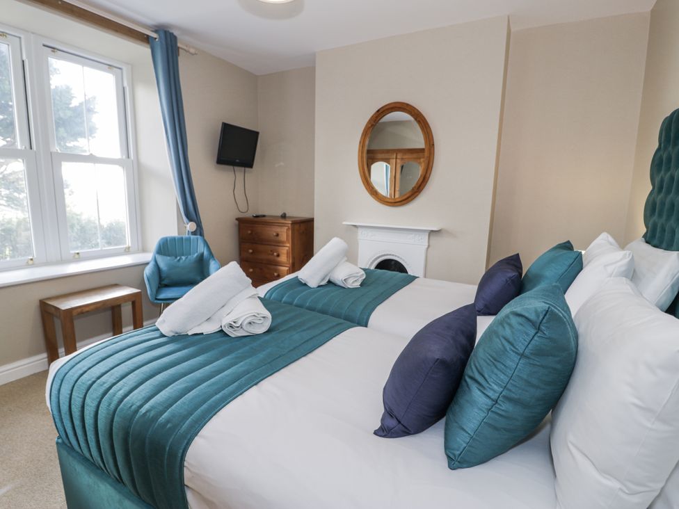 A bedroom with two beds at Tyddyn Goronwy in Talybont