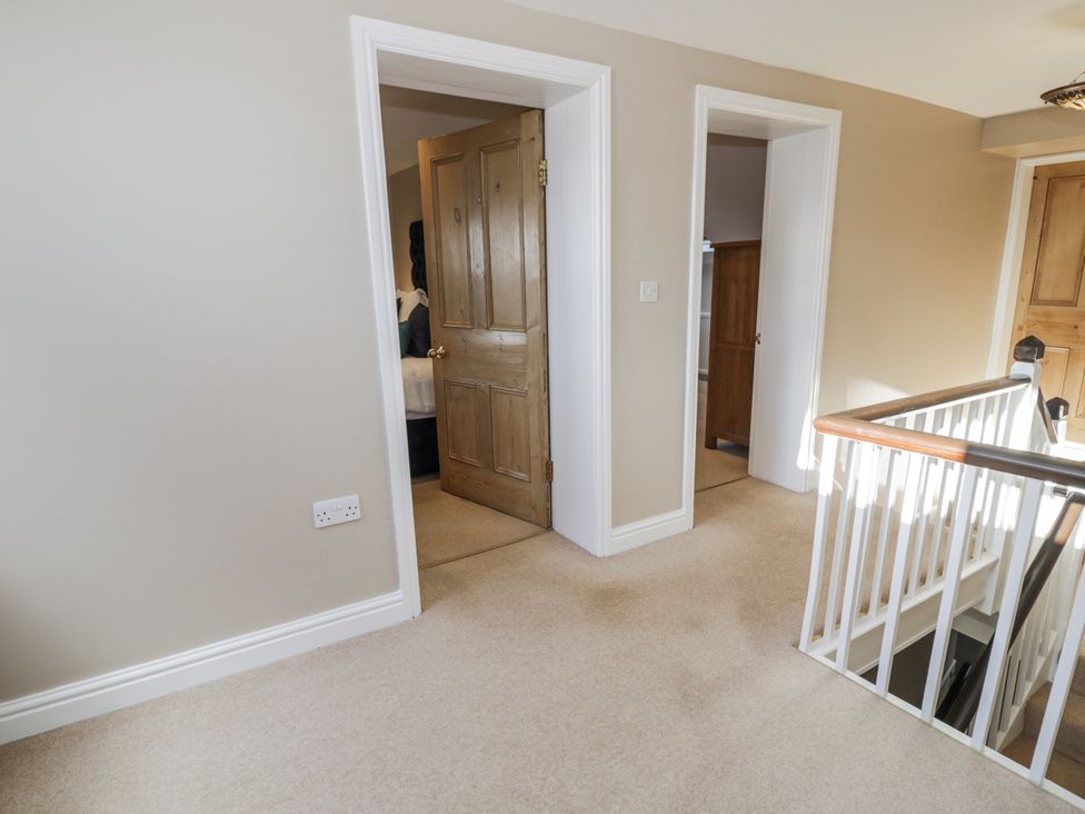 A hallway with doors at Tyddyn Goronwy Talybont