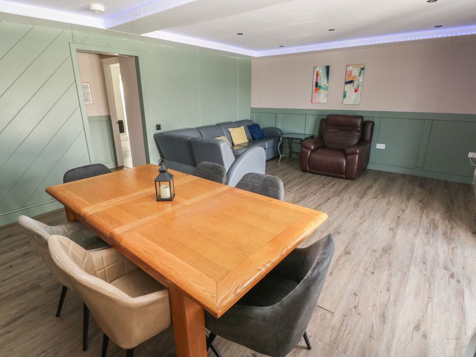 A dining room with a table and chairs at Meadow View in Laugharne