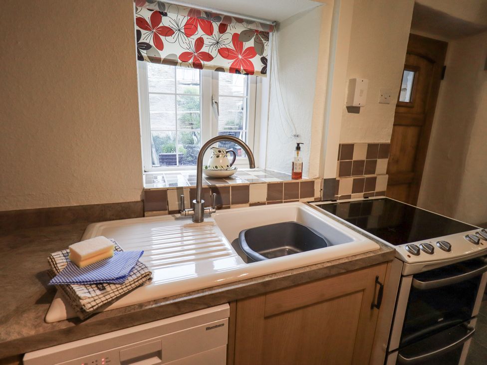 A kitchen featuring a sink, stove, and window at Harber Scar in Horton-in-Ribblesdale near Settle