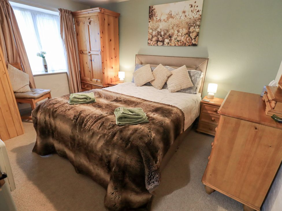 A bedroom with a bed and wooden furniture at Harber Scar in Horton-in-Ribblesdale near Settle