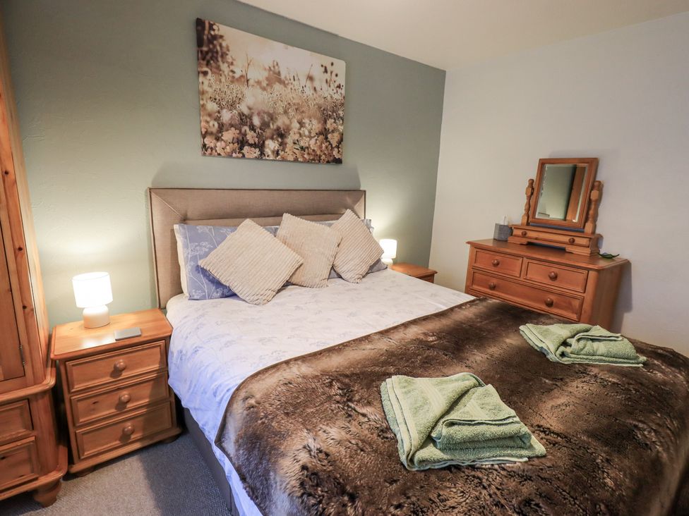 A bedroom with a bed and dresser at Harber Scar in Horton-in-Ribblesdale near Settle