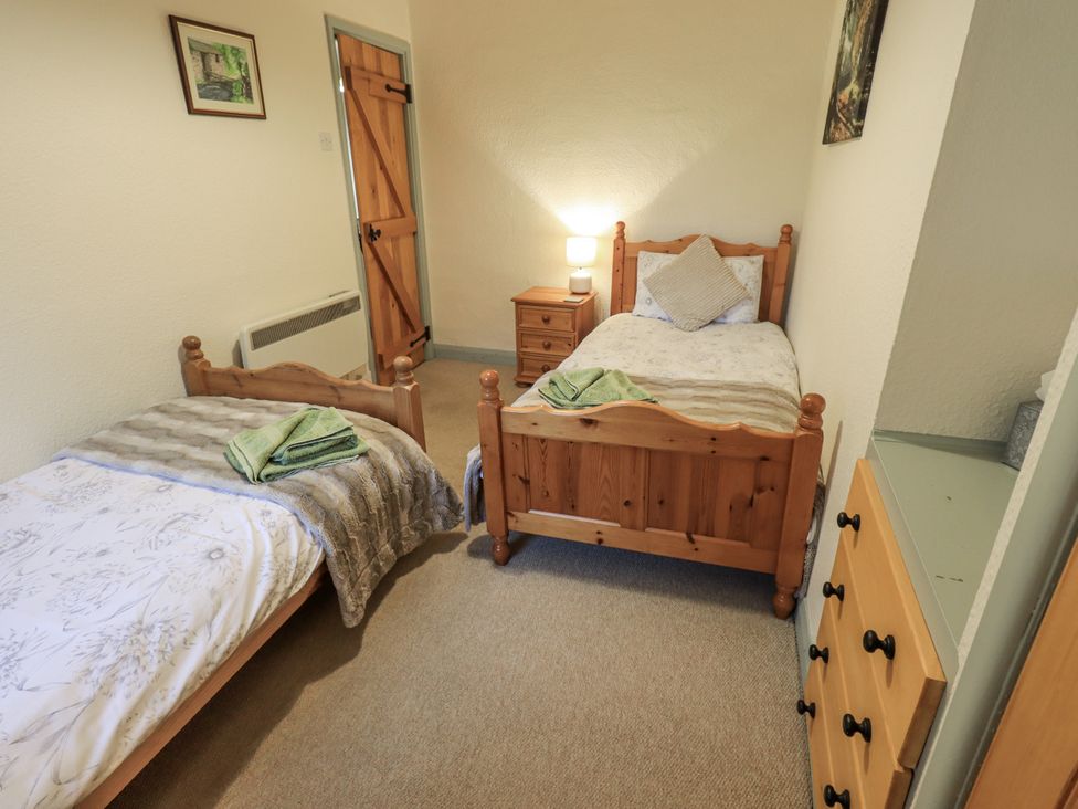 A bedroom with two beds and a nightstand at Harber Scar Horton-in-Ribblesdale near Settle