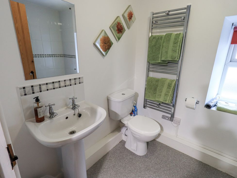 A bathroom with a sink, toilet, and towel rack at Harber Scar in Horton-in-Ribblesdale near Settle