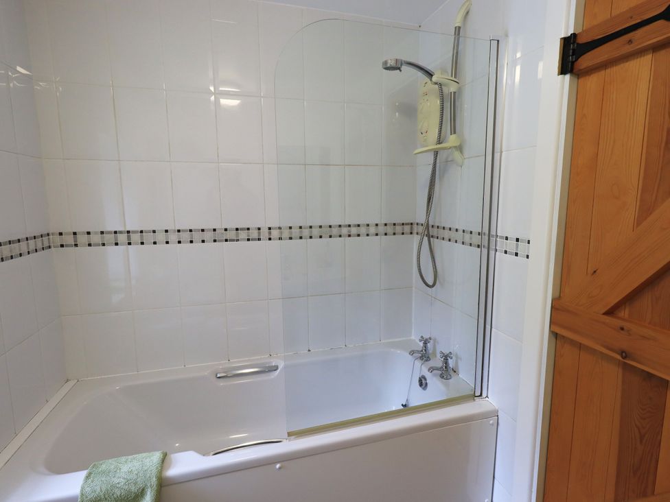A bathroom with a shower over a bathtub at Harber Scar in Horton-in-Ribblesdale near Settle