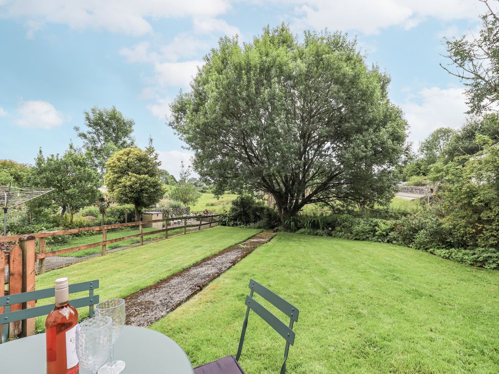 A garden with a tree and table with chairs at Harber Scar Horton-in-Ribblesdale near Settle