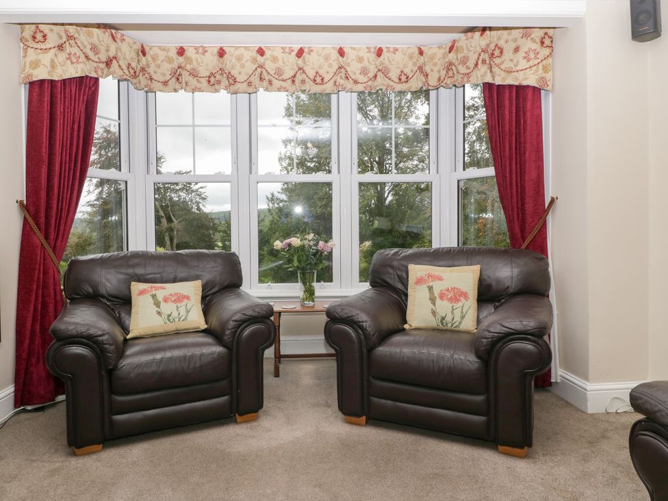 A living room with armchairs and a window view at The Croft in Vowchurch near Peterchurch