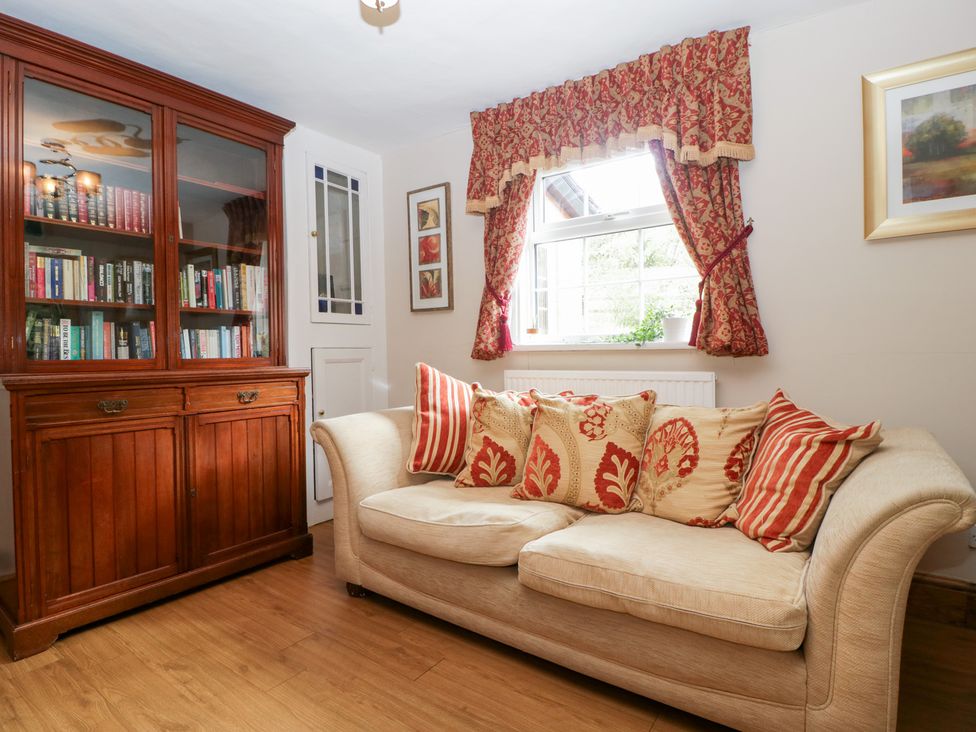 A living room with a sofa and bookcase at The Croft in Vowchurch near Peterchurch