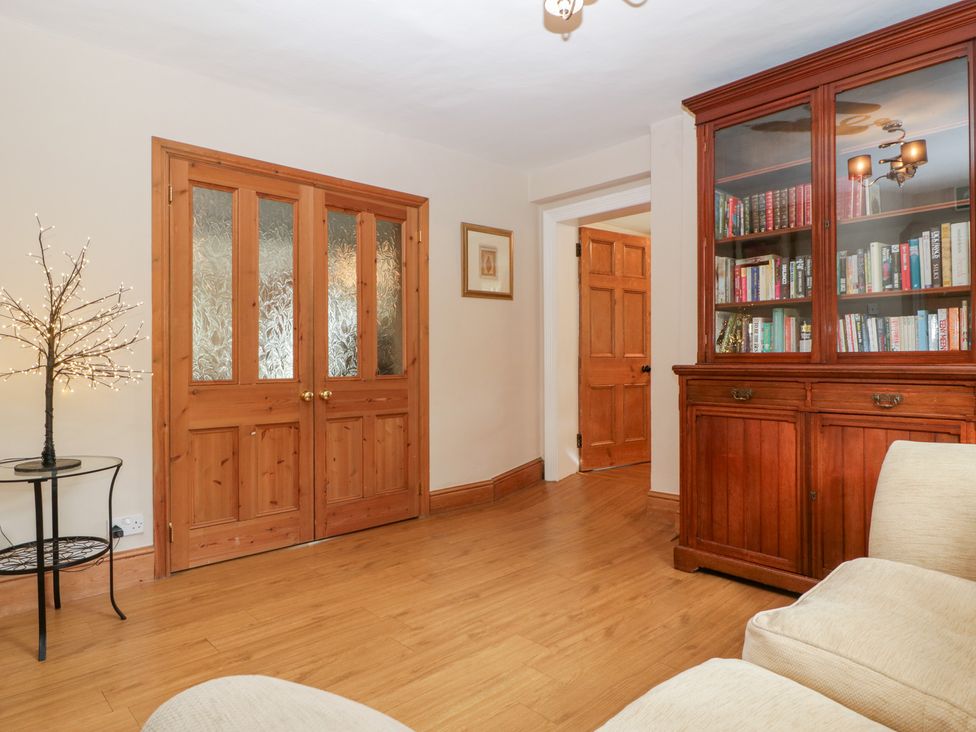 A snug with wooden doors and bookshelf at The Croft Vowchurch near Peterchurch
