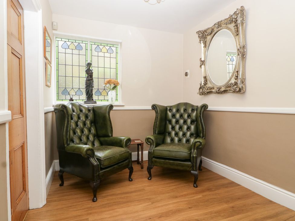 A living room with two armchairs and a statue at The Croft Vowchurch near Peterchurch