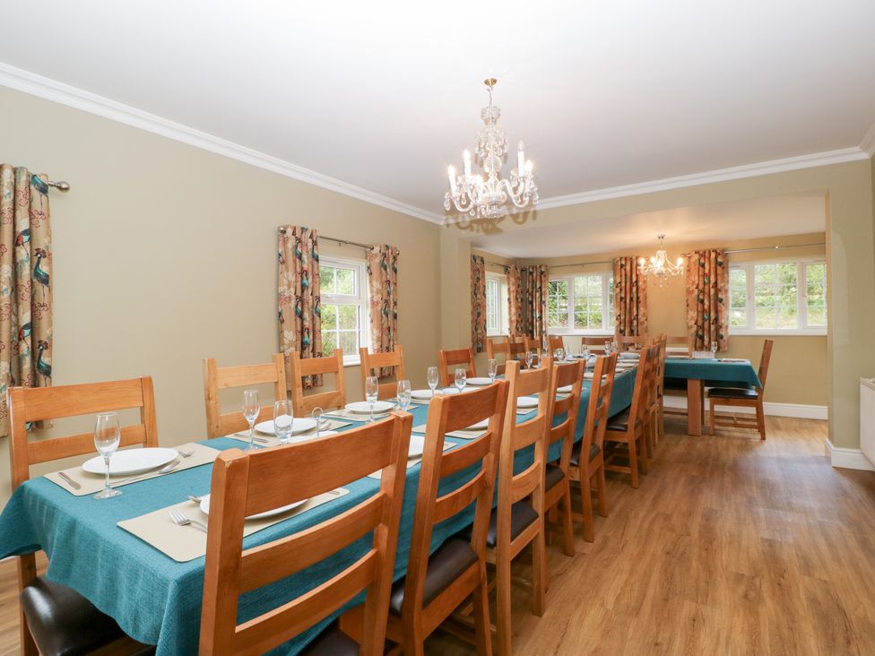 A dining room with a long table and chairs at The Croft in Vowchurch near Peterchurch