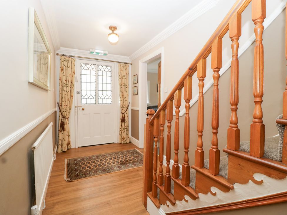 A hallway with a staircase and a front door at The Croft in Vowchurch near Peterchurch