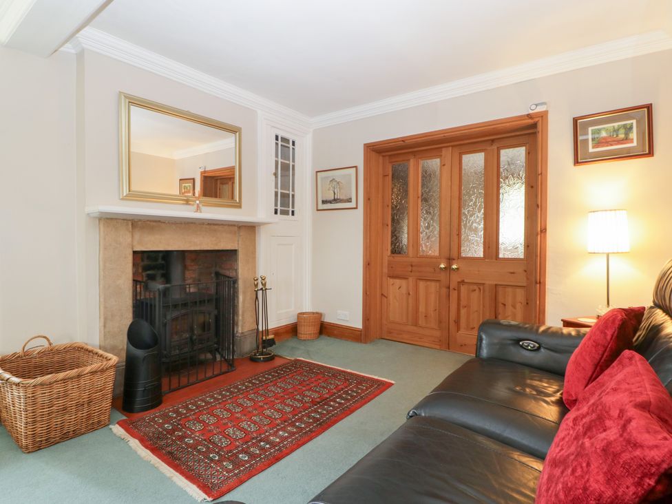 A living room with a fireplace and sofa at The Croft in Vowchurch near Peterchurch