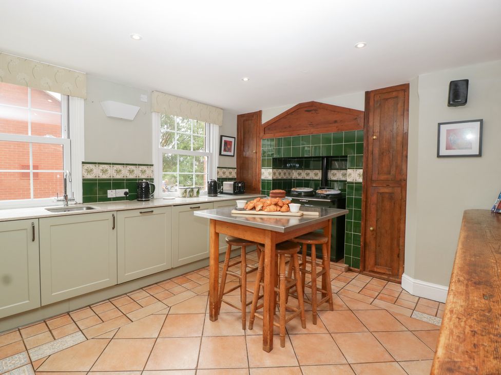 A kitchen with a sink, stove, and table with croissants at The Croft in Vowchurch near Peterchurch