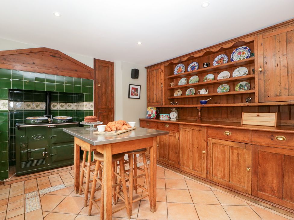 A kitchen with a cooker and wooden shelves at The Croft in Vowchurch near Peterchurch