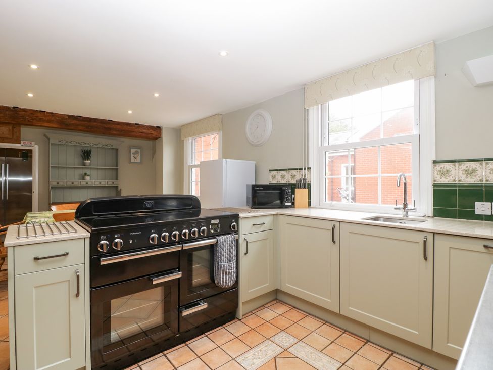 A kitchen with a stove, oven, sink, and refrigerator at The Croft in Vowchurch near Peterchurch