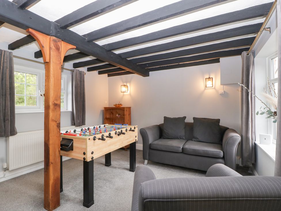 A snug with a foosball table and a sofa at The Croft in Vowchurch near Peterchurch