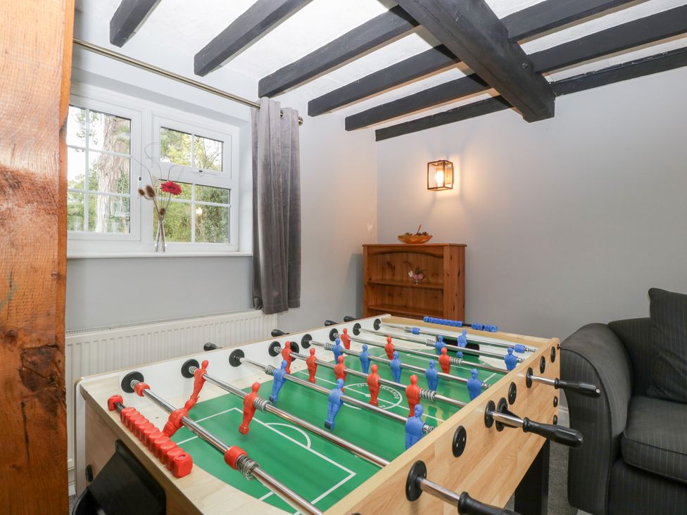 A snug with a foosball table and sofa at The Croft Vowchurch near Peterchurch
