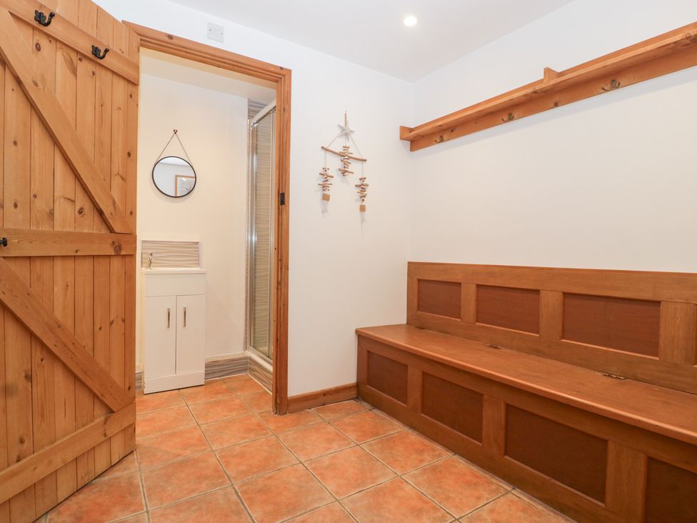 An entryway with bench and mirror at The Croft in Vowchurch near Peterchurch