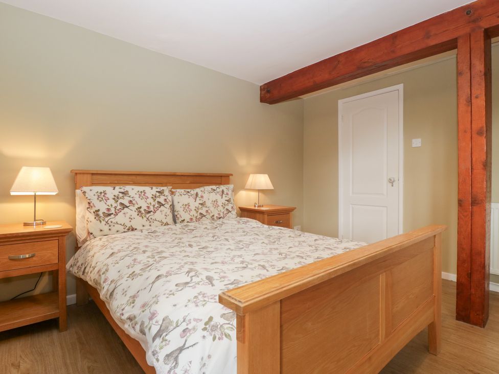 A bedroom with a bed and bedside tables at The Croft in Vowchurch near Peterchurch